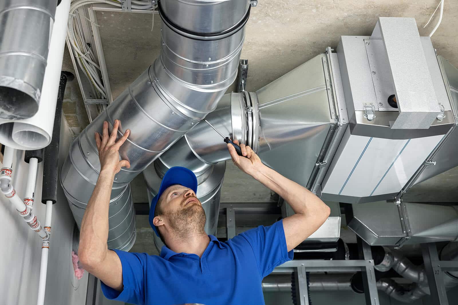HVAC technician inspecting and repairing air ducts in La Puente